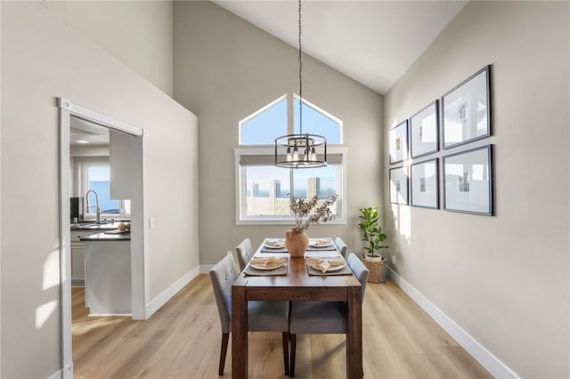 747 Highland View Dr, Corona, CA 92882 - dining room featuring a chandelier, light wood finished floors, and a high ceiling