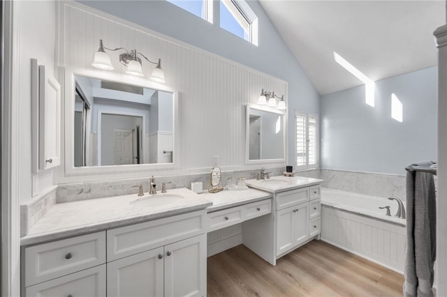 747 Highland View Dr, Corona, CA 92882 - full bath with double vanity, a bath, healthy amount of natural light, wood finished floors, and high vaulted ceiling