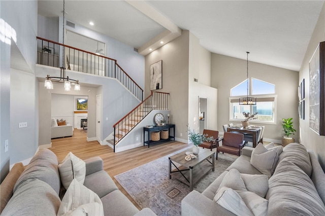 747 Highland View Dr, Corona, CA 92882 - living area featuring a chandelier, high vaulted ceiling, stairway, wood finished floors, and a fireplace
