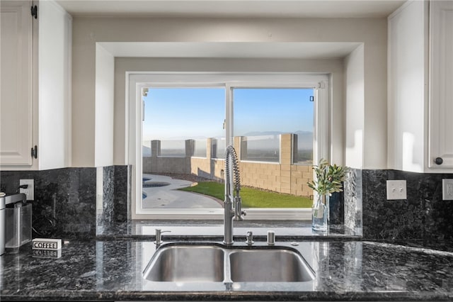 747 Highland View Dr, Corona, CA 92882 - kitchen with dark stone counters, backsplash, and white cabinets