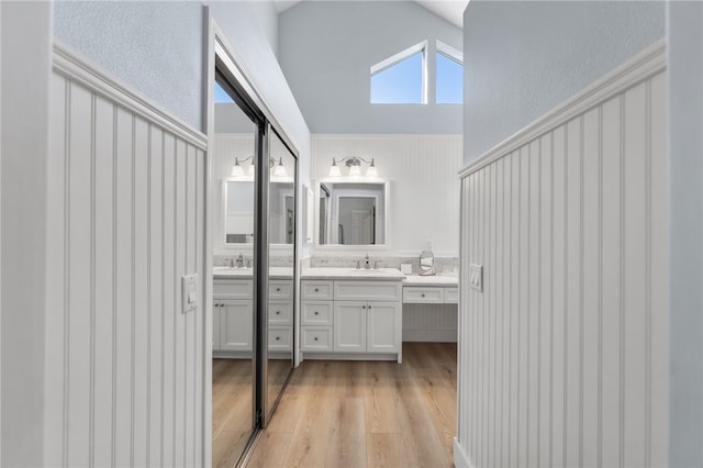 747 Highland View Dr, Corona, CA 92882 - bathroom featuring double vanity, wood finished floors, and vaulted ceiling