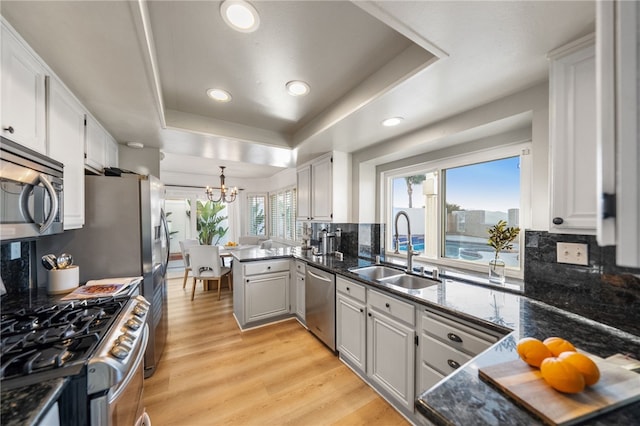747 Highland View Dr, Corona, CA 92882 - kitchen featuring stainless steel appliances, a chandelier, decorative backsplash, light wood-style floors, and recessed lighting