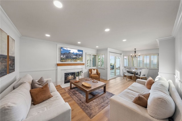 747 Highland View Dr, Corona, CA 92882 - living room featuring crown molding, a chandelier, recessed lighting, light wood-style flooring, and a premium fireplace