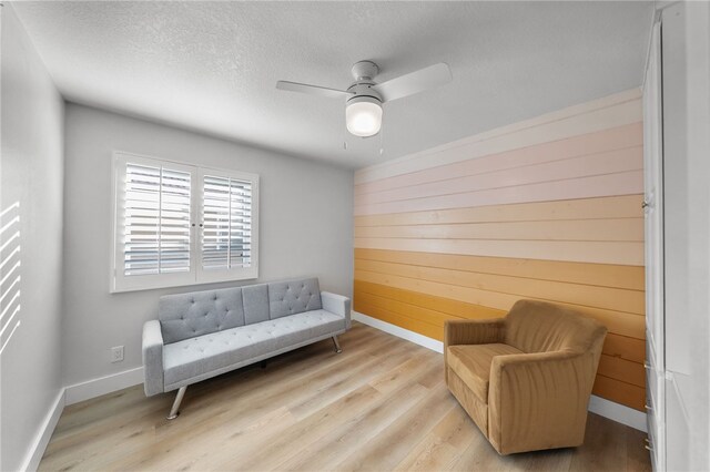 747 Highland View Dr, Corona, CA 92882 - sitting room featuring wood finished floors, ceiling fan, a textured ceiling, and wood walls