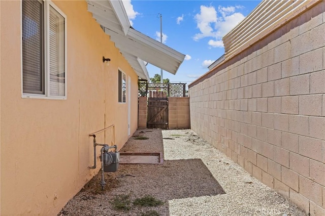 38953 Foxholm Dr, Palmdale, CA 93551 - view of side of property with stucco siding and a gate
