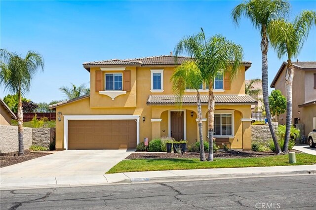 23004 Seattle Ridge Rd, Wildomar, CA 92595 - mediterranean / spanish house featuring concrete driveway, stucco siding, a tiled roof, and a garage