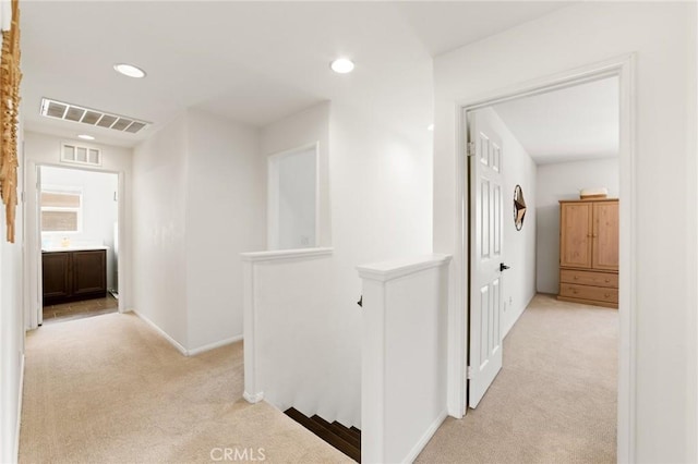 23004 Seattle Ridge Rd, Wildomar, CA 92595 - corridor featuring light colored carpet, an upstairs landing, and recessed lighting