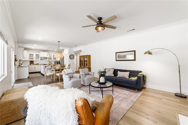 23004 Seattle Ridge Rd, Wildomar, CA 92595 - living room featuring recessed lighting, ceiling fan, ornamental molding, and wood finished floors