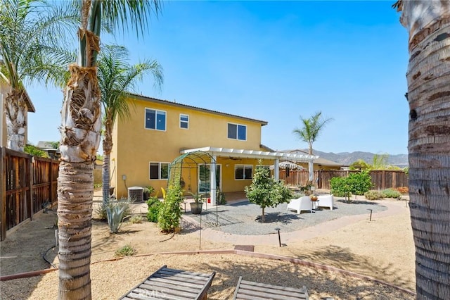 23004 Seattle Ridge Rd, Wildomar, CA 92595 - back of house with a pergola, stucco siding, a patio, a fenced backyard, and a mountain view