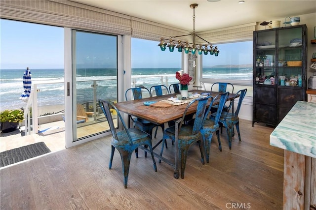 3436 Studio Dr, Cayucos, CA 93430 - dining area with wood finished floors and view of water and beach