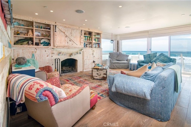 3436 Studio Dr, Cayucos, CA 93430 - living room featuring wood finished floors, a high end fireplace, a water view, and recessed lighting