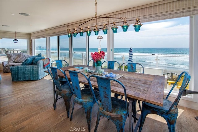 3436 Studio Dr, Cayucos, CA 93430 - dining space featuring wood finished floors, view of water and beach, and healthy amount of natural light