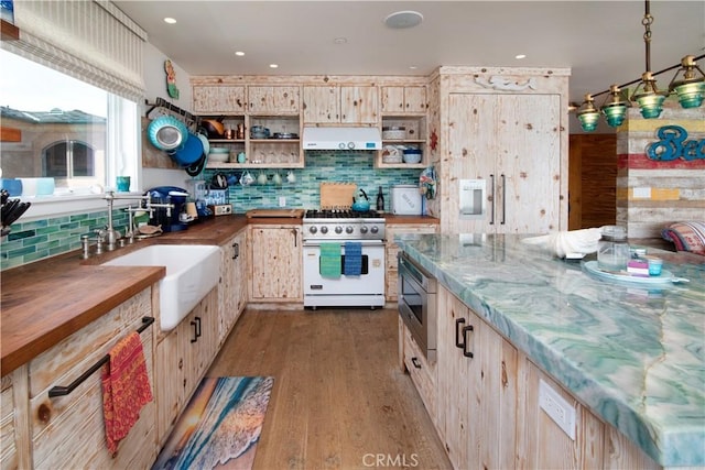 3436 Studio Dr, Cayucos, CA 93430 - kitchen featuring high end stove, stainless steel microwave, ventilation hood, open shelves, and wood counters