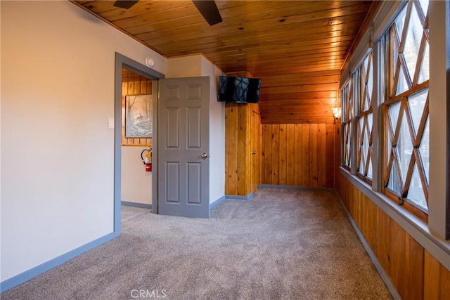 1025 W Big Bear Blvd, Big Bear City, CA 92314 - spare room with wooden ceiling, carpet floors, a ceiling fan, plenty of natural light, and wood walls