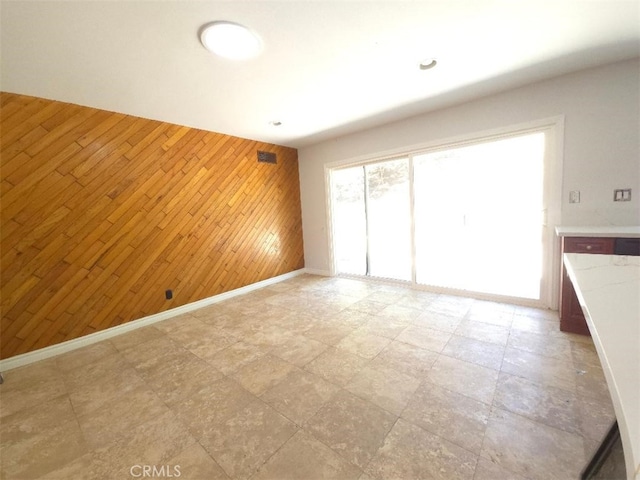 22127 Halsted St, Chatsworth, CA 91311 - empty room featuring wood walls and an accent wall