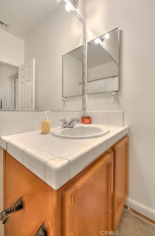 1503 Lynwood Way, Highland, CA 92346 - bathroom featuring vanity and tasteful backsplash