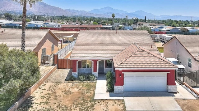 1503 Lynwood Way, Highland, CA 92346 - view of front of home with stone siding, a tiled roof, driveway, and a garage