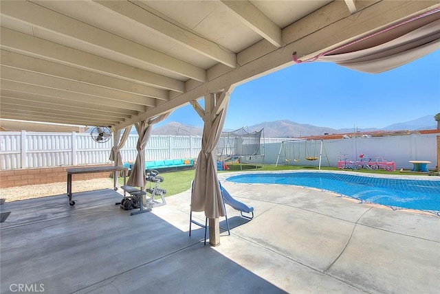 1503 Lynwood Way, Highland, CA 92346 - view of swimming pool with a trampoline, a patio, a fenced backyard, and a mountain view