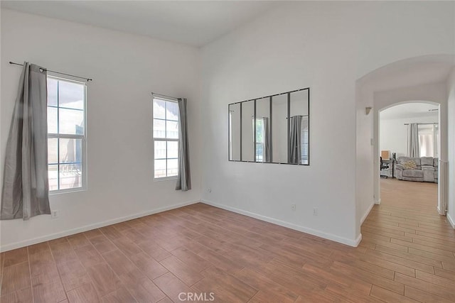 1503 Lynwood Way, Highland, CA 92346 - empty room featuring arched walkways and wood finished floors