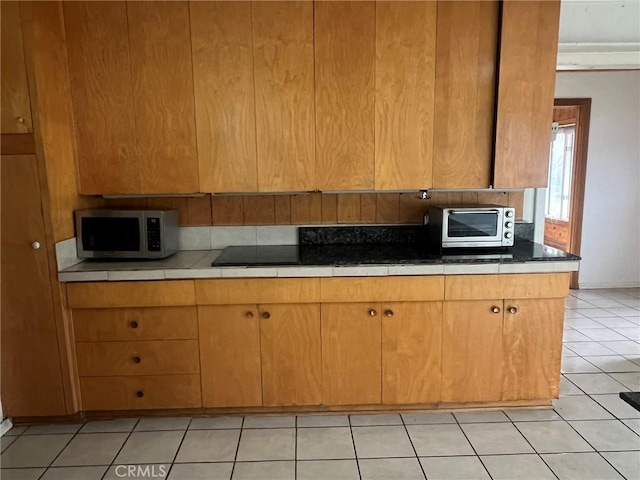 196 Meadow Ln, Crestline, CA 92322 - kitchen with stainless steel microwave and light tile patterned flooring