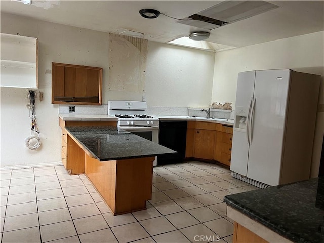 196 Meadow Ln, Crestline, CA 92322 - kitchen with white appliances, light tile patterned floors, dark stone countertops, and a peninsula