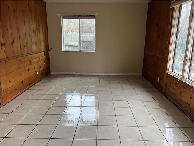 196 Meadow Ln, Crestline, CA 92322 - unfurnished room featuring healthy amount of natural light, light tile patterned floors, and wood walls