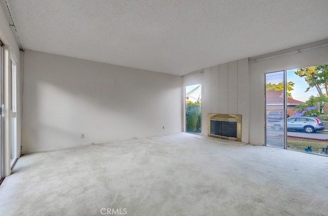 27909 Alaflora Dr, Rancho Palos Verdes, CA 90275 - unfurnished living room with healthy amount of natural light, carpet flooring, and a fireplace
