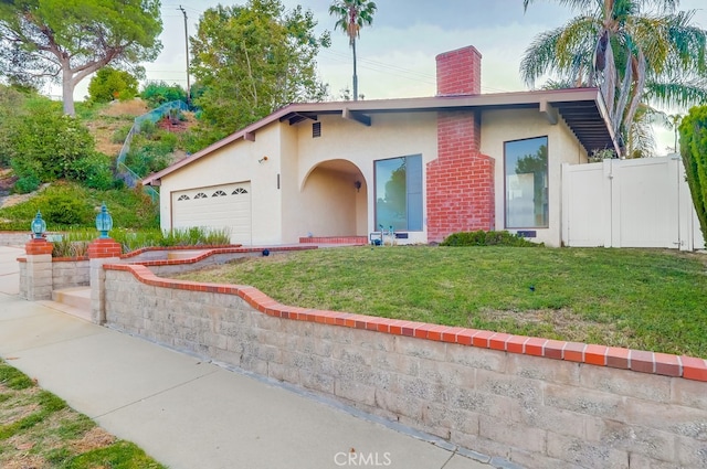27909 Alaflora Dr, Rancho Palos Verdes, CA 90275 - view of front of house with stucco siding, a chimney, and a garage