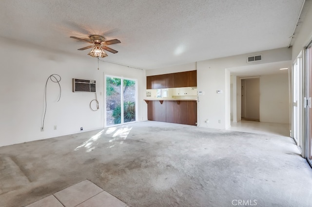 27909 Alaflora Dr, Rancho Palos Verdes, CA 90275 - unfurnished living room featuring ceiling fan, an AC wall unit, a textured ceiling, and light colored carpet