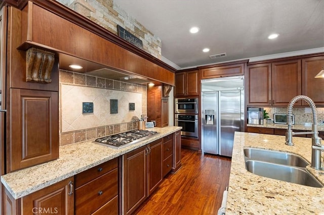 22517 Skipping Stone Dr, Saugus, CA 91350 - kitchen with stainless steel appliances, decorative backsplash, dark wood finished floors, light stone counters, and recessed lighting
