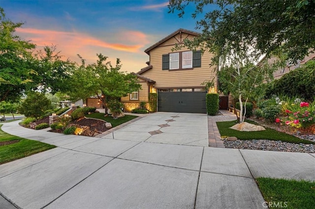 22517 Skipping Stone Dr, Saugus, CA 91350 - view of front of house with concrete driveway, a garage, and stone siding