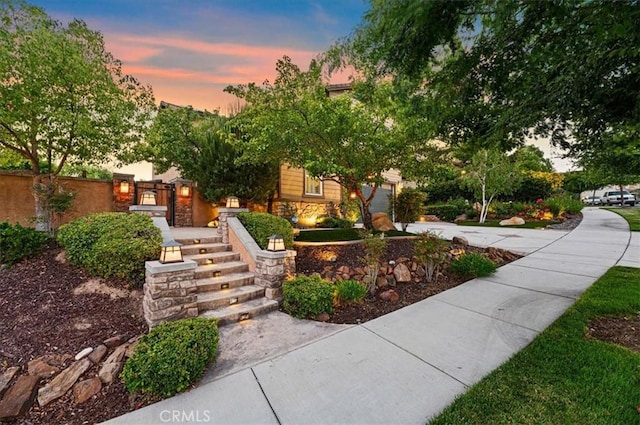 22517 Skipping Stone Dr, Saugus, CA 91350 - obstructed view of property with concrete driveway, stone siding, and an attached garage