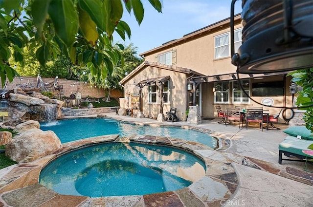 22517 Skipping Stone Dr, Saugus, CA 91350 - view of swimming pool featuring a pool with connected hot tub, a patio area, and a fenced backyard