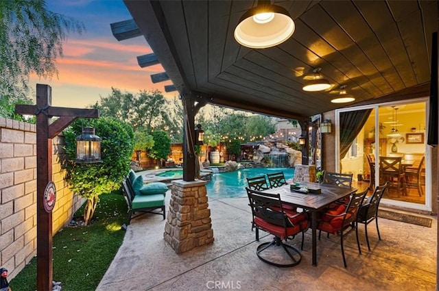 22517 Skipping Stone Dr, Saugus, CA 91350 - patio terrace at dusk featuring a patio, a fenced backyard, outdoor dining area, and a pool with connected hot tub
