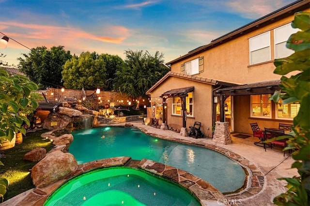 22517 Skipping Stone Dr, Saugus, CA 91350 - pool at dusk with a pool with connected hot tub, a pergola, and a patio