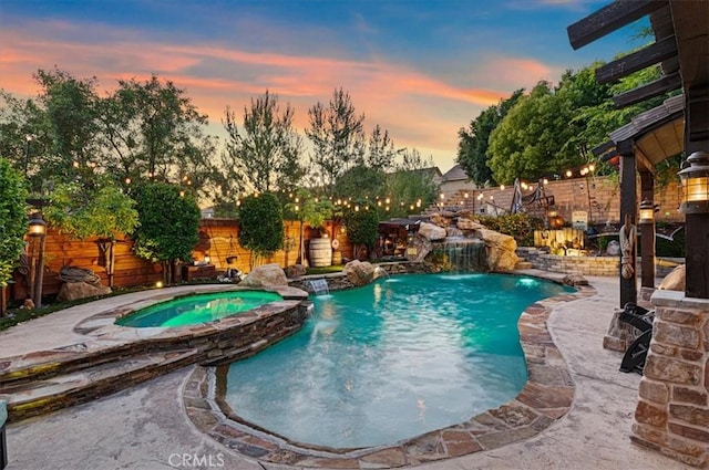 22517 Skipping Stone Dr, Saugus, CA 91350 - pool at dusk featuring a fenced backyard and a pool with connected hot tub