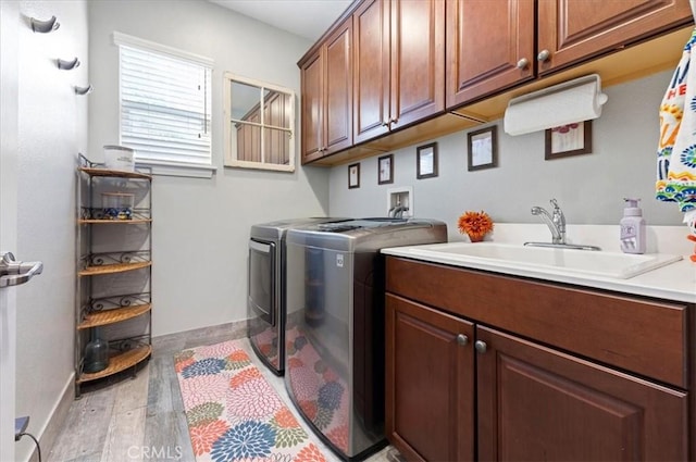 22517 Skipping Stone Dr, Saugus, CA 91350 - washroom featuring washer and clothes dryer, cabinet space, and light wood-style flooring