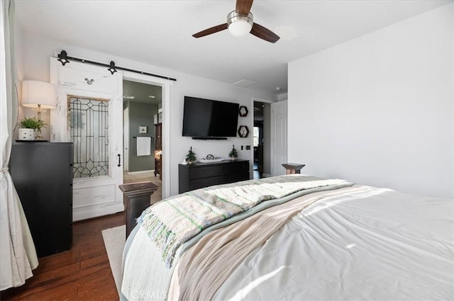22517 Skipping Stone Dr, Saugus, CA 91350 - bedroom with wood finished floors, a barn door, and a ceiling fan
