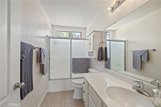 11361 Foxglove Ln, Corona, CA 92878 - bathroom featuring vanity, shower / bath combination with glass door, a textured ceiling, and wood finished floors