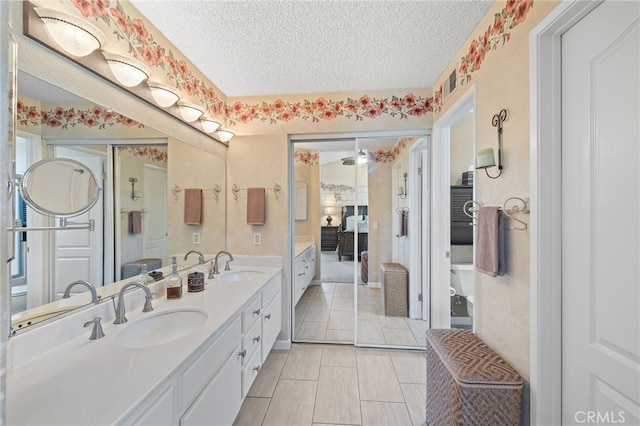11361 Foxglove Ln, Corona, CA 92878 - full bathroom with double vanity, a textured ceiling, and ensuite bathroom