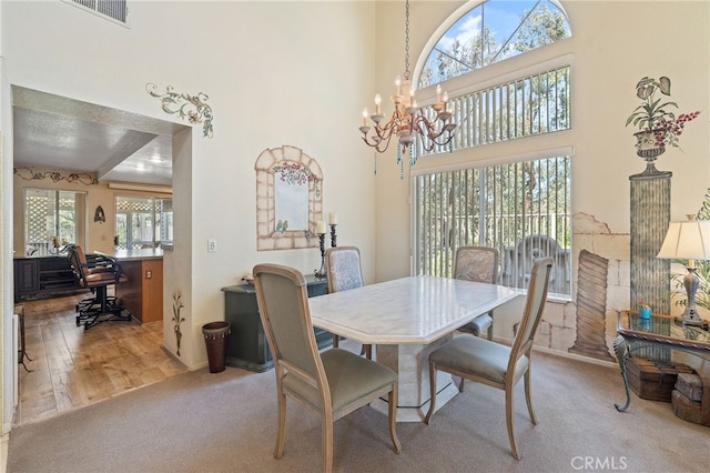11361 Foxglove Ln, Corona, CA 92878 - carpeted dining room featuring a chandelier and a high ceiling