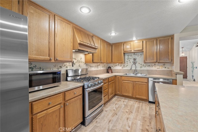 11361 Foxglove Ln, Corona, CA 92878 - kitchen with stainless steel appliances, light countertops, custom range hood, light wood finished floors, and recessed lighting