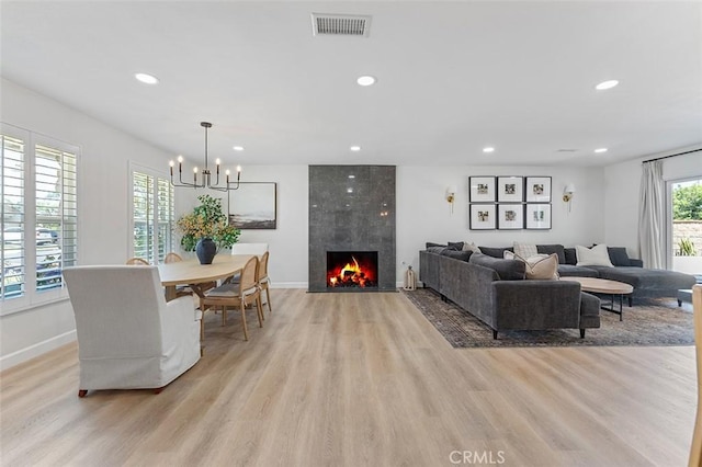 927 E Fairway Dr, Orange, CA 92866 - living area with light wood finished floors, recessed lighting, a chandelier, and a fireplace
