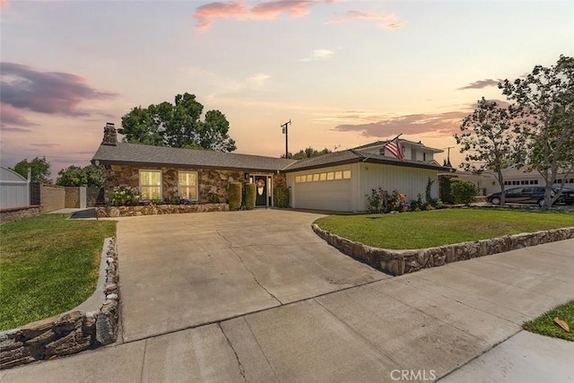 927 E Fairway Dr, Orange, CA 92866 - view of front facade featuring an attached garage, concrete driveway, a front lawn, a chimney, and stone siding