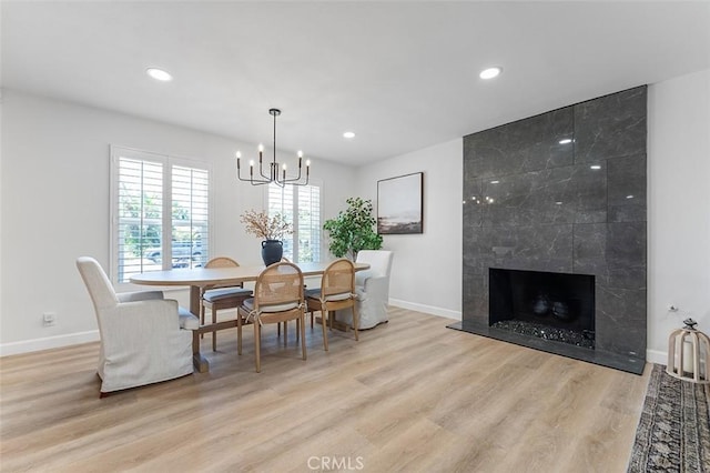 927 E Fairway Dr, Orange, CA 92866 - dining space featuring wood finished floors, a chandelier, recessed lighting, and a high end fireplace
