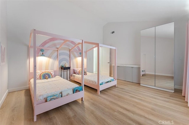 927 E Fairway Dr, Orange, CA 92866 - bedroom featuring light wood-style floors, high vaulted ceiling, and a closet