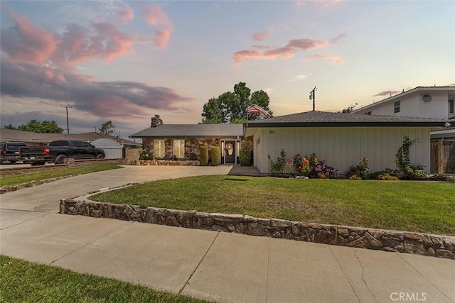 927 E Fairway Dr, Orange, CA 92866 - view of front facade with curved driveway, a yard, and a chimney