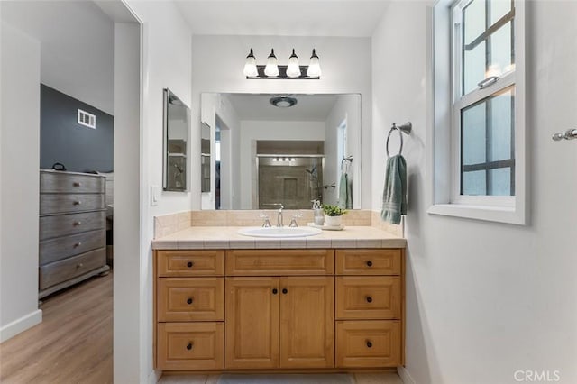 927 E Fairway Dr, Orange, CA 92866 - bathroom featuring vanity, a stall shower, and wood finished floors