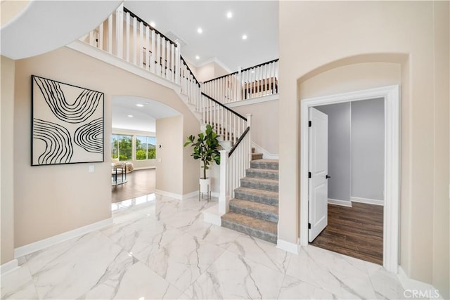 16389 Viewcrest Rd, Chino Hills, CA 91709 - foyer entrance featuring marble finish flooring, arched walkways, stairway, recessed lighting, and a high ceiling