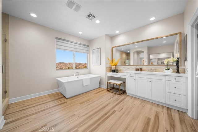 16389 Viewcrest Rd, Chino Hills, CA 91709 - bathroom featuring a soaking tub, wood finished floors, vanity, a tile shower, and recessed lighting